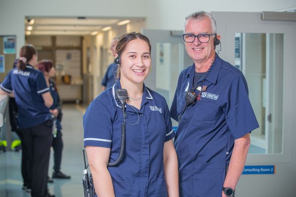 Two nurses stand together in health centre