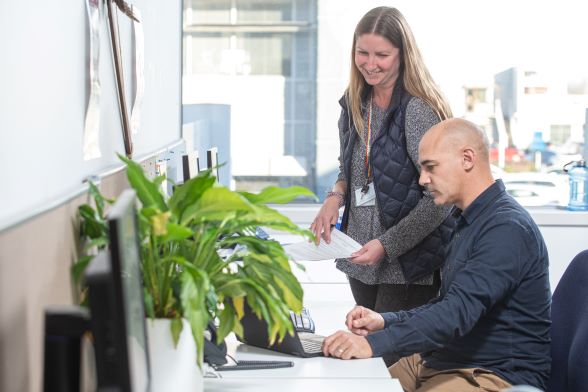 Programme Facilitators work together at desk